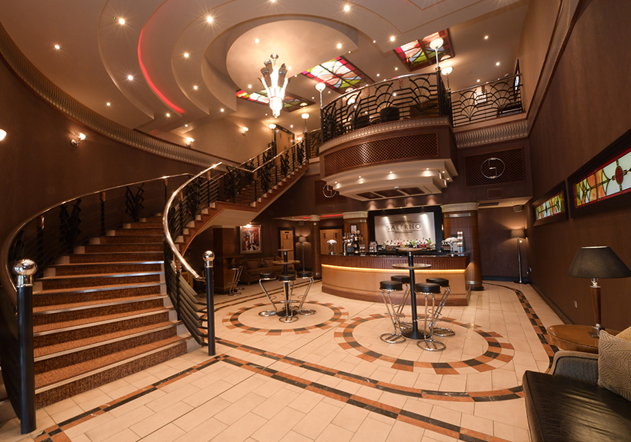 Foyer bar area with mahogany staircase and platform